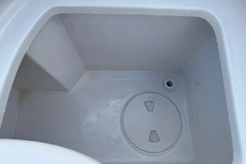 Slide: The Image of Interior compartment of 2021 Sea Hunt Ultra 305 SE boat, featuring a drain plug. - 30