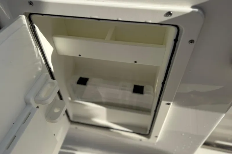 Slide: The Image of Open storage compartment on 2021 Sea Hunt Ultra 305 SE boat. - 32