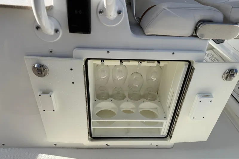 Slide: The Image of 2021 Sea Hunt Ultra 305 SE boat with built-in glass storage compartment. - 33