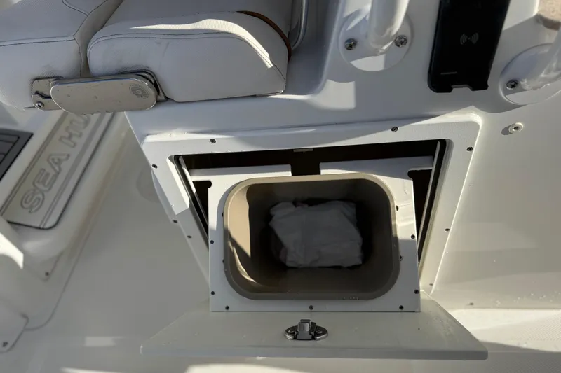 Slide: The Image of 2021 Sea Hunt Ultra 305 SE boat storage compartment with cushioned seating. - 37
