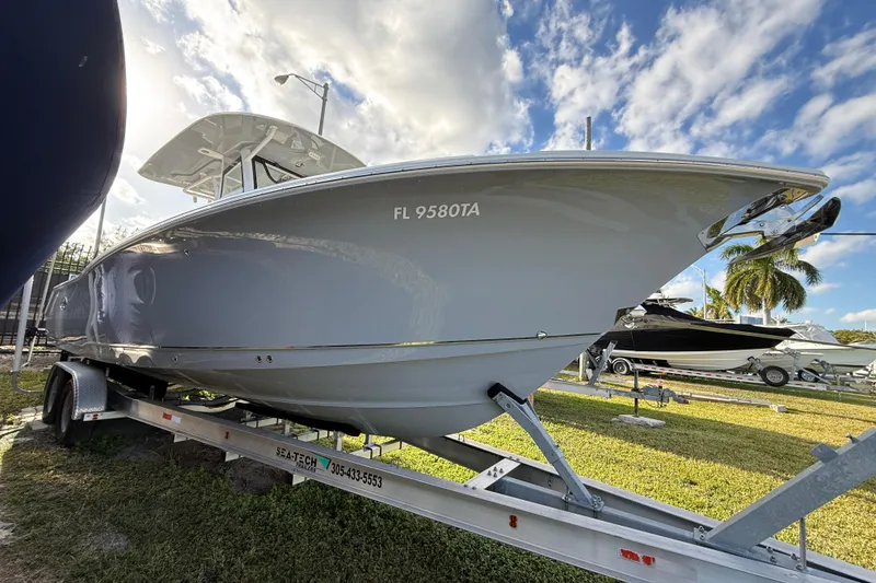 Slide: The Image of 2021 Sea Hunt Ultra 305 SE boat on trailer under blue sky. - 4