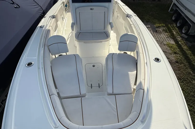 Slide: The Image of 2021 Sea Hunt Ultra 305 SE boat interior with white seating and spacious layout. - 7