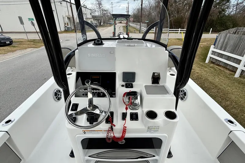 Slide: The Image of 2021 Sea Pro 248 Bay boat dashboard with steering wheel and controls. - 11
