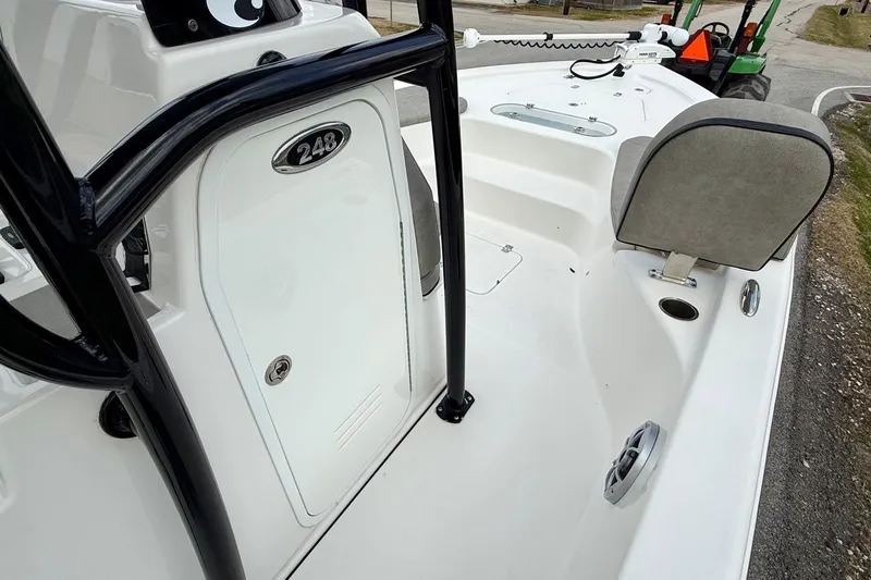 Slide: The Image of 2021 Sea Pro 248 Bay boat interior with seating and storage compartment. - 15