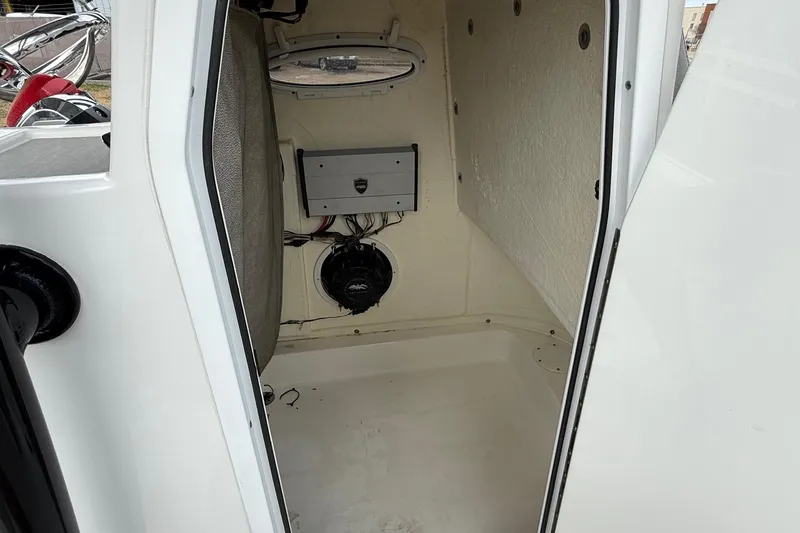 Slide: The Image of 2021 Sea Pro 248 Bay boat interior with speaker and storage compartment. - 16