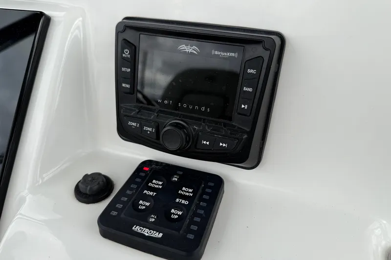 Slide: The Image of 2021 Sea Pro 248 Bay boat audio and control panel featuring Wet Sounds and Lectrotab systems. - 20
