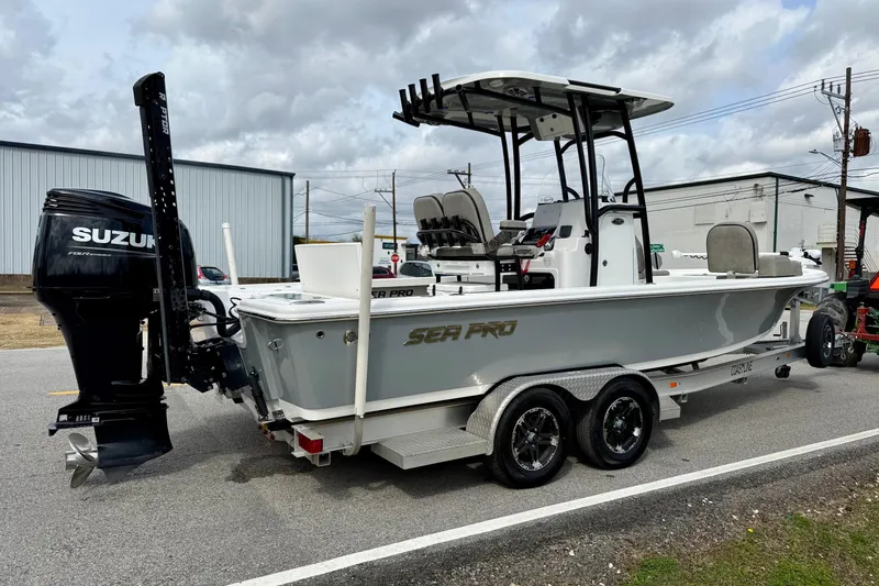 Slide: The Image of 2021 Sea Pro 248 Bay boat with Suzuki engine on a trailer, parked outdoors. - 4