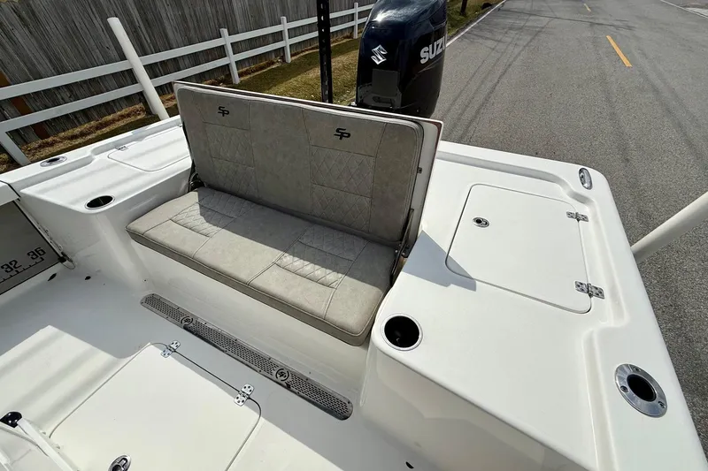 Slide: The Image of 2021 Sea Pro 248 Bay boat with cushioned seating and Suzuki outboard motor. - 7