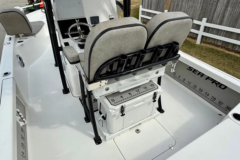 Slide: The Image of 2021 Sea Pro 248 Bay boat interior with seating and rod holders. - 9