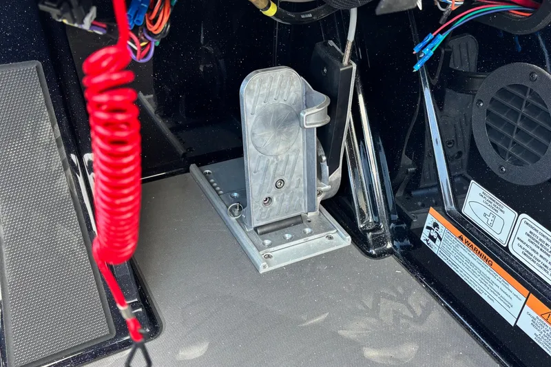 Slide: The Image of 2026 Ranger Z520R boat foot pedal and wiring detail with safety warning labels. - 12