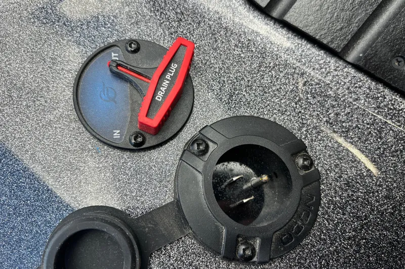 Slide: The Image of Close-up of 2026 Ranger Z520R boat drain plug and socket on textured surface. - 17