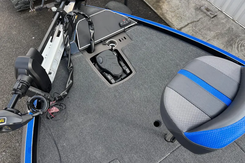 Slide: The Image of 2026 Ranger Z520R boat deck with trolling motor and blue-accented seat. - 6