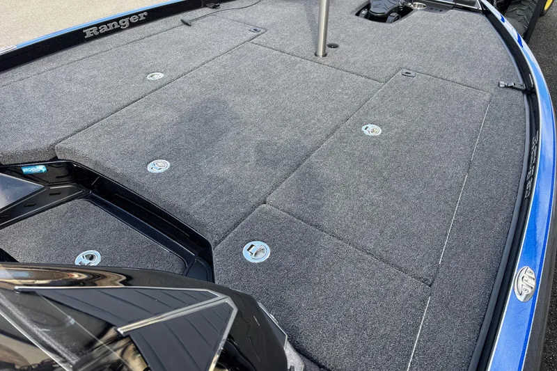 Slide: The Image of 2026 Ranger Z520R boat deck with gray carpet and storage compartments. - 7