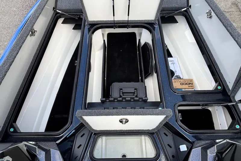 Slide: The Image of 2026 Ranger Z520R boat storage compartments open, showcasing organized interior layout. - 8