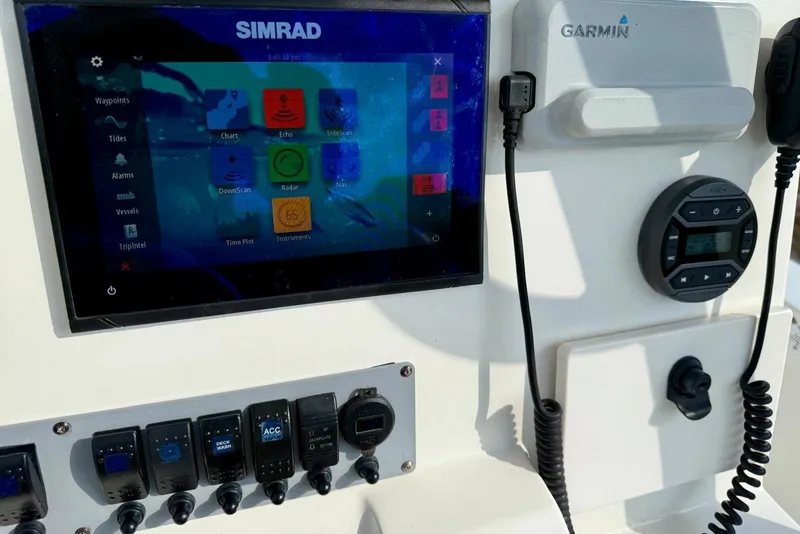 Slide: The Image of Control panel of 2017 Seaborn FX24 Bay boat with Simrad and Garmin electronics. - 19