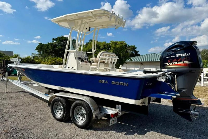 Slide: The Image of 2017 Seaborn FX24 Bay boat on trailer with Yamaha outboard motor, under blue sky. - 29