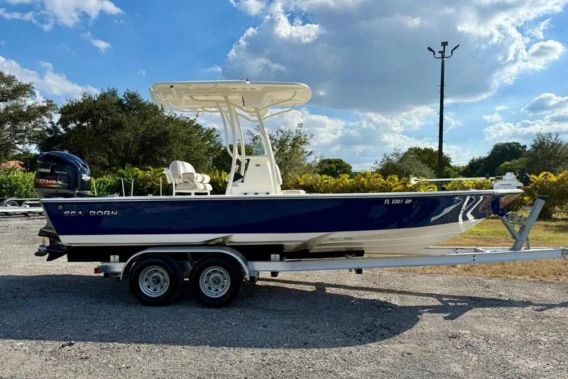 Slide: The Image of 2017 Seaborn FX24 Bay boat on trailer under blue sky. - 3