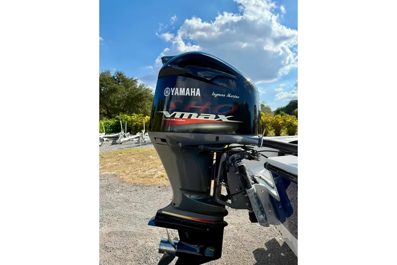 Slide: The Image of Yamaha VMAX outboard motor on 2017 Seaborn FX24 Bay boat under clear sky. - 31