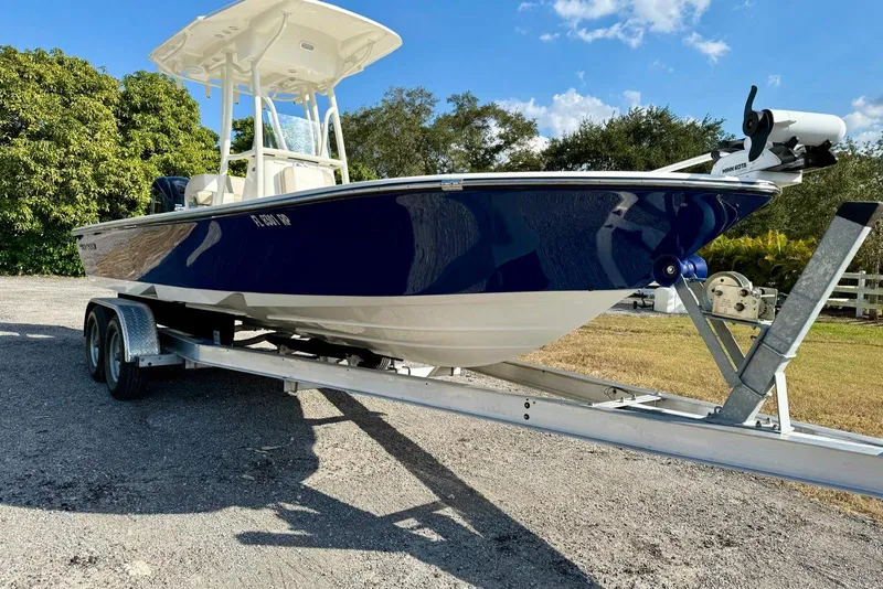 Slide: The Image of 2017 Seaborn FX24 Bay boat on trailer, parked outdoors under blue sky. - 5