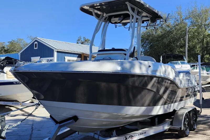 The Image of 2022 Finseeker 230 CC boat on trailer, displayed outdoors. - 0