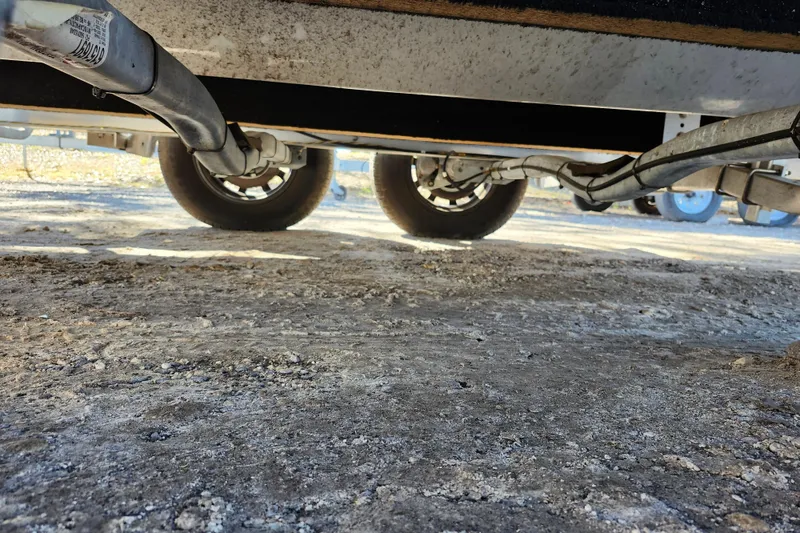 Slide: The Image of Underneath view of a 2022 Finseeker 230 CC trailer, showing wheels and suspension. - 12