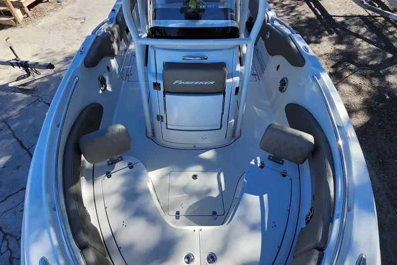 Slide: The Image of 2022 Finseeker 230 CC boat interior with seating and storage compartments. - 13