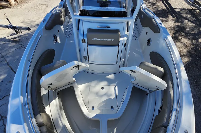 Slide: The Image of 2022 Finseeker 230 CC boat interior with open storage compartments and seating. - 14