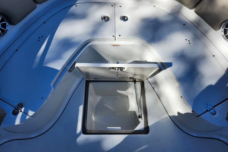 Slide: The Image of 2022 Finseeker 230 CC boat deck with open storage compartment. - 15
