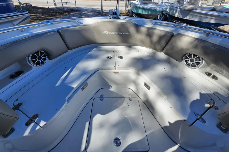 Slide: The Image of 2022 Finseeker 230 CC boat interior with seating and speakers. - 16