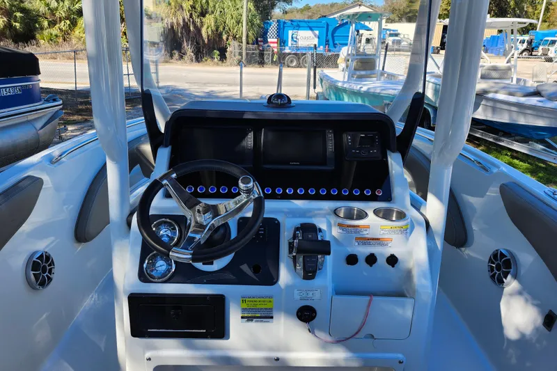 Slide: The Image of 2022 Finseeker 230 CC boat dashboard with steering wheel and controls. - 27