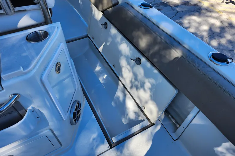 Slide: The Image of 2022 Finseeker 230 CC boat interior with storage compartment and seating area. - 28