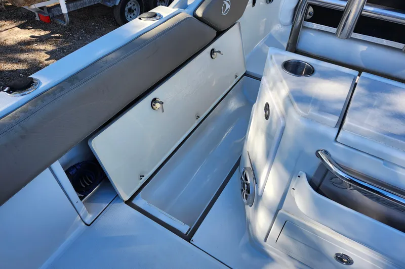 Slide: The Image of 2022 Finseeker 230 CC boat interior with storage compartments and seating area. - 29