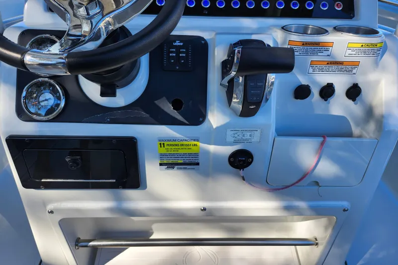 Slide: The Image of Control panel of 2022 Finseeker 230 CC boat with steering wheel and gauges. - 32