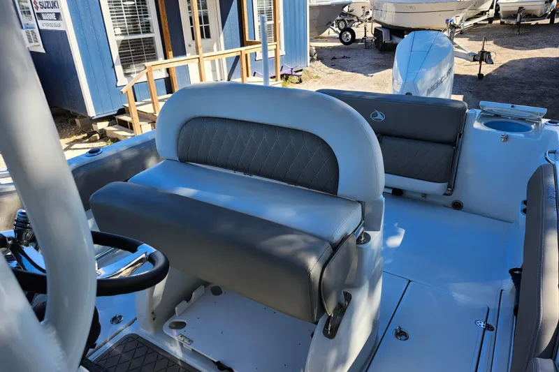 Slide: The Image of 2022 Finseeker 230 CC boat interior with gray seating and steering wheel. - 34
