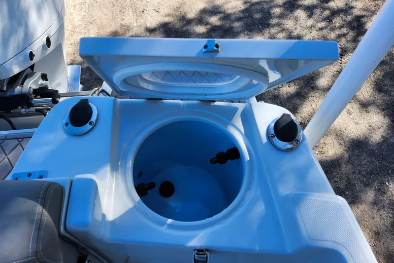 Slide: The Image of Open storage compartment on 2022 Finseeker 230 CC boat, showing interior details. - 36