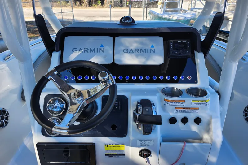 Slide: The Image of 2022 Finseeker 230 CC boat dashboard with Garmin displays and steering wheel. - 41