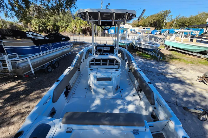 Slide: The Image of 2022 Finseeker 230 CC boat with spacious deck and modern console, parked outdoors. - 44