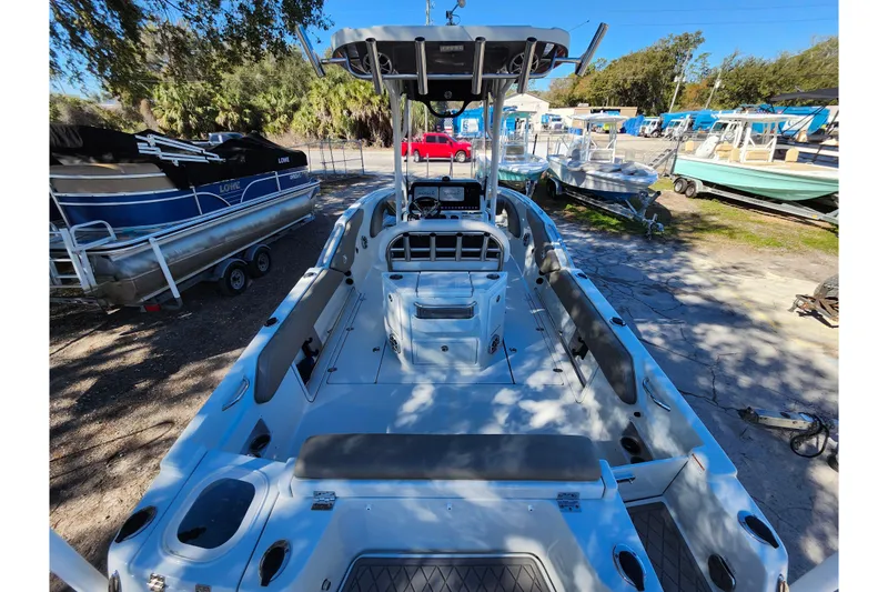 Slide: The Image of 2022 Finseeker 230 CC boat interior, docked with other boats in a sunny marina. - 45