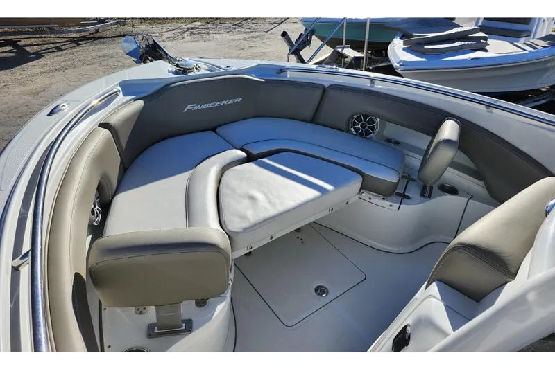 Slide: The Image of 2022 Finseeker 230 CC boat interior with cushioned seating and modern design. - 46