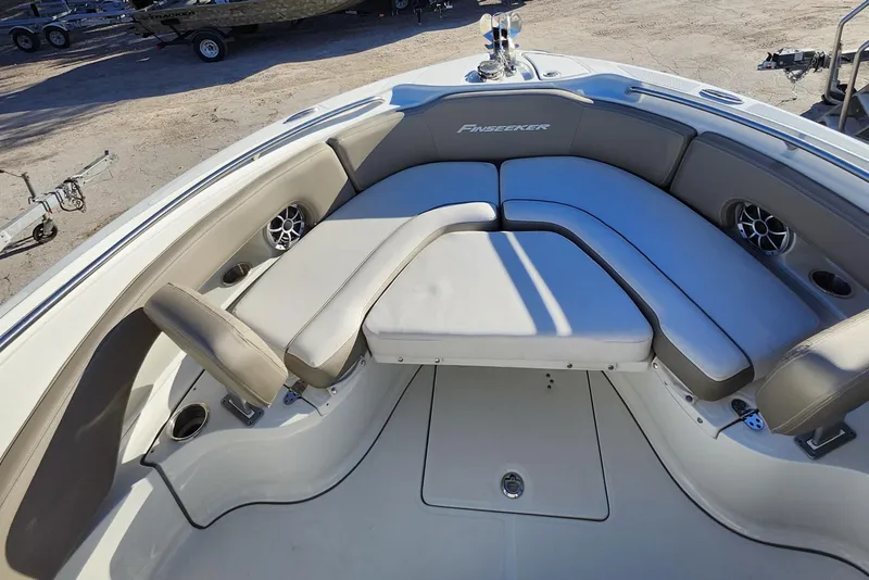 Slide: The Image of 2022 Finseeker 230 CC boat interior with cushioned seating and cup holders. - 48