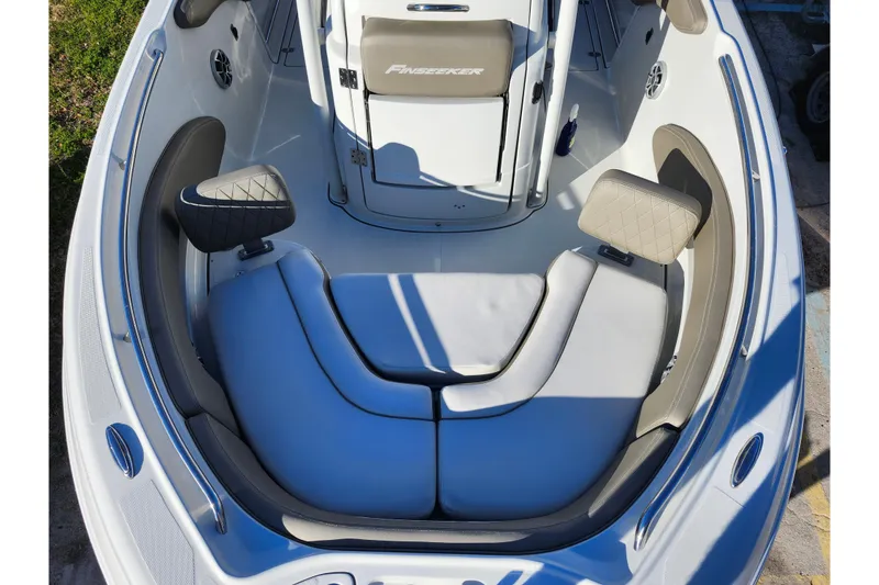 Slide: The Image of 2022 Finseeker 230 CC boat interior with cushioned seating and modern design. - 49