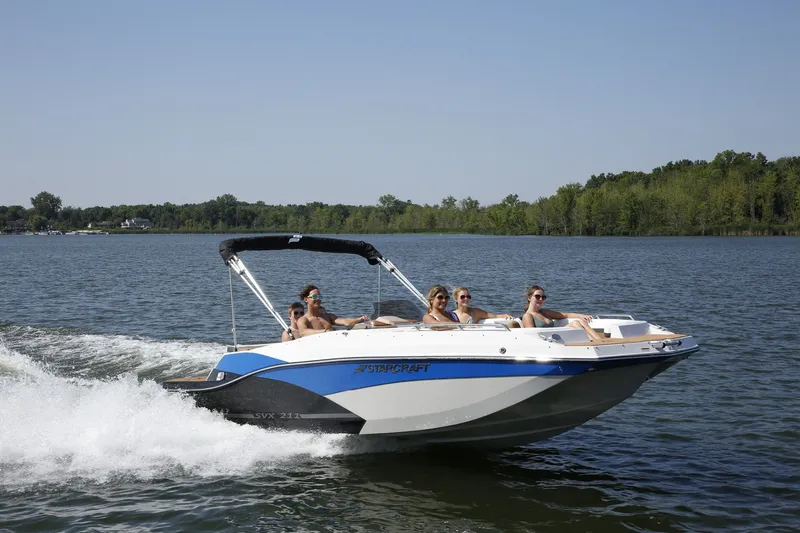 Slide: The Image of Starcraft 211SVXIO 2026 boat cruising on a lake with passengers. - 3