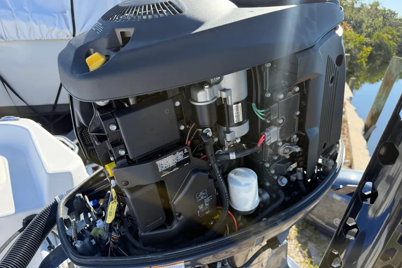 Slide: The Image of Close-up of a 2002 Cobia 191 Bay boat engine, showcasing internal components. - 12