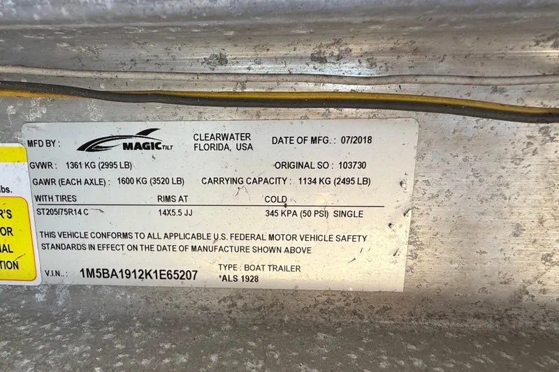 Slide: The Image of Sticker on a 2002 Cobia 191 Bay boat trailer, detailing weight and manufacturing information. - 20