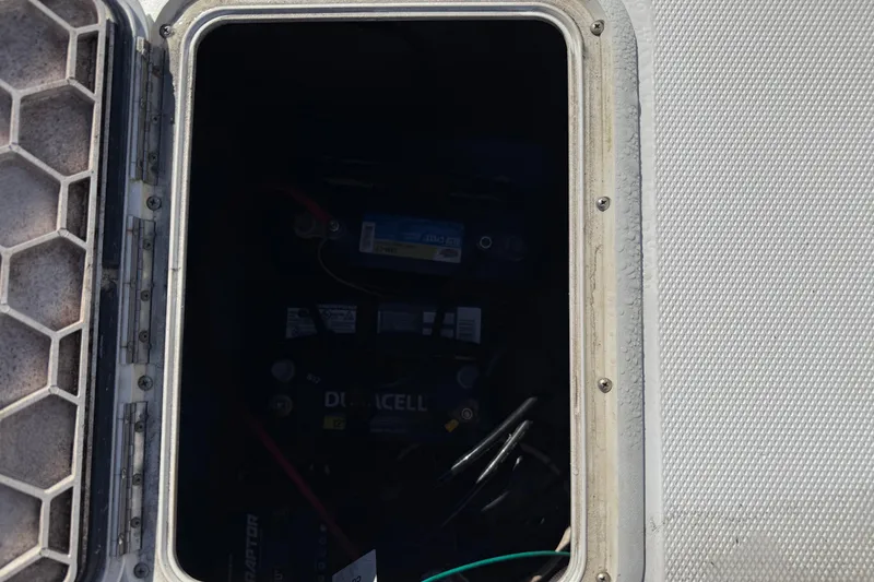 Slide: The Image of Open hatch of 2002 Cobia 191 Bay boat showing battery compartment. - 22