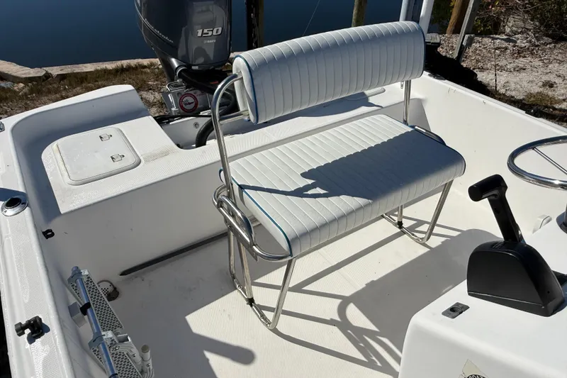 Slide: The Image of 2002 Cobia 191 Bay boat interior with seating and Yamaha 150 engine. - 26