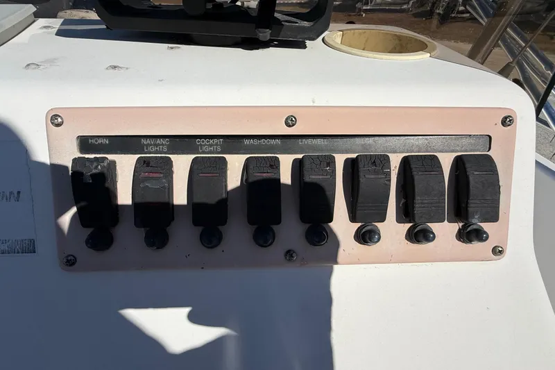 Slide: The Image of Control panel of a 2002 Cobia 191 Bay boat with labeled switches. - 30