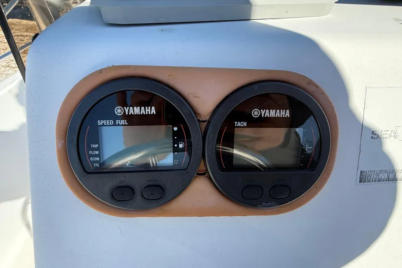 Slide: The Image of Yamaha gauges on a 2002 Cobia 191 Bay boat dashboard. - 31