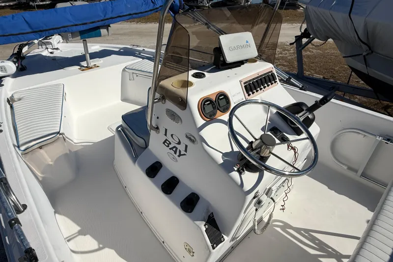 Slide: The Image of 2002 Cobia 191 Bay boat interior with steering wheel and Garmin navigation system. - 32