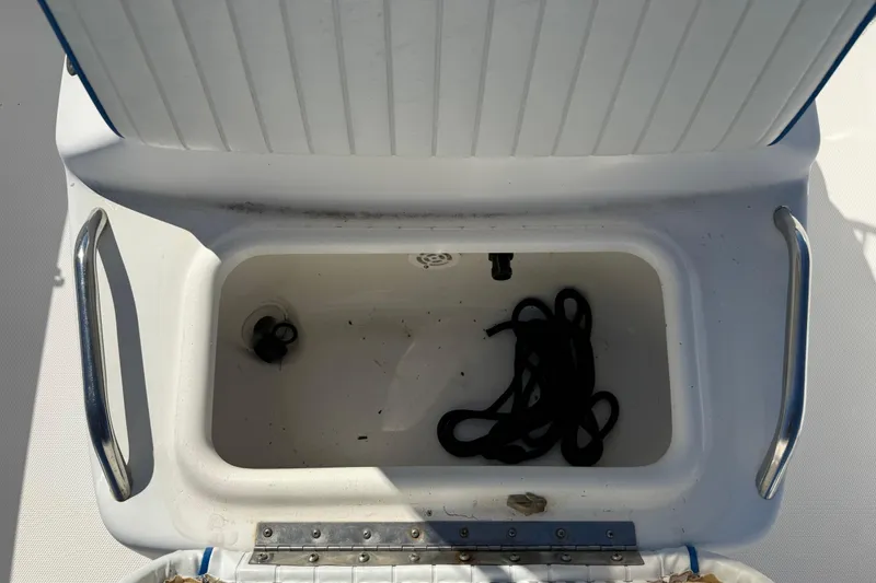 Slide: The Image of Open storage compartment on 2002 Cobia 191 Bay boat with rope inside. - 36